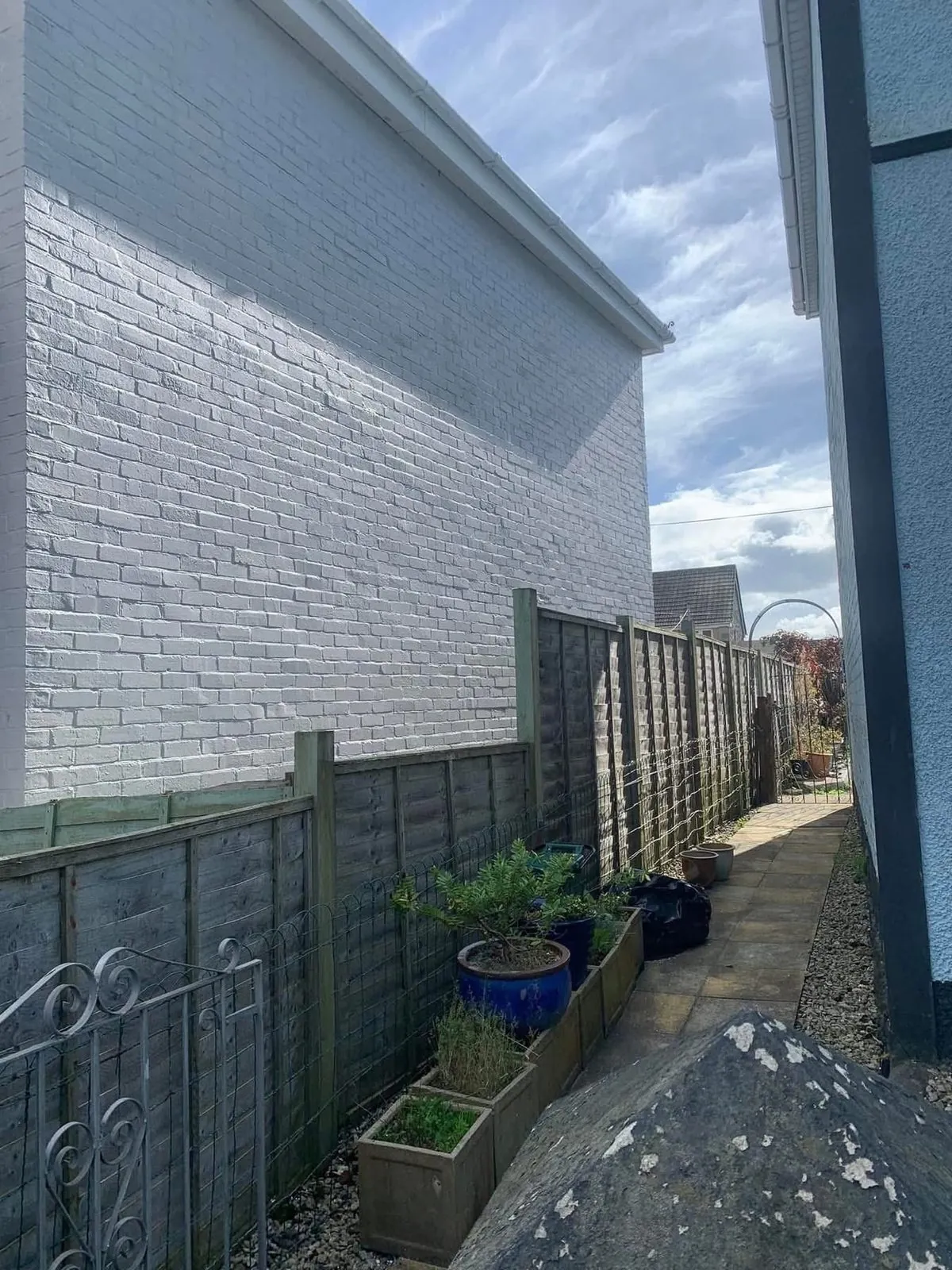 Freshly painted brick wall after preparation and masonry paint in Bodmin